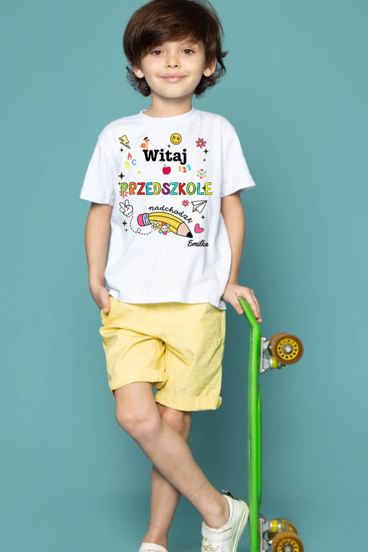 front-view-cute-child-boy-white-t-shirt-yellow-jeans-holding-green-skateboard-blue-floor